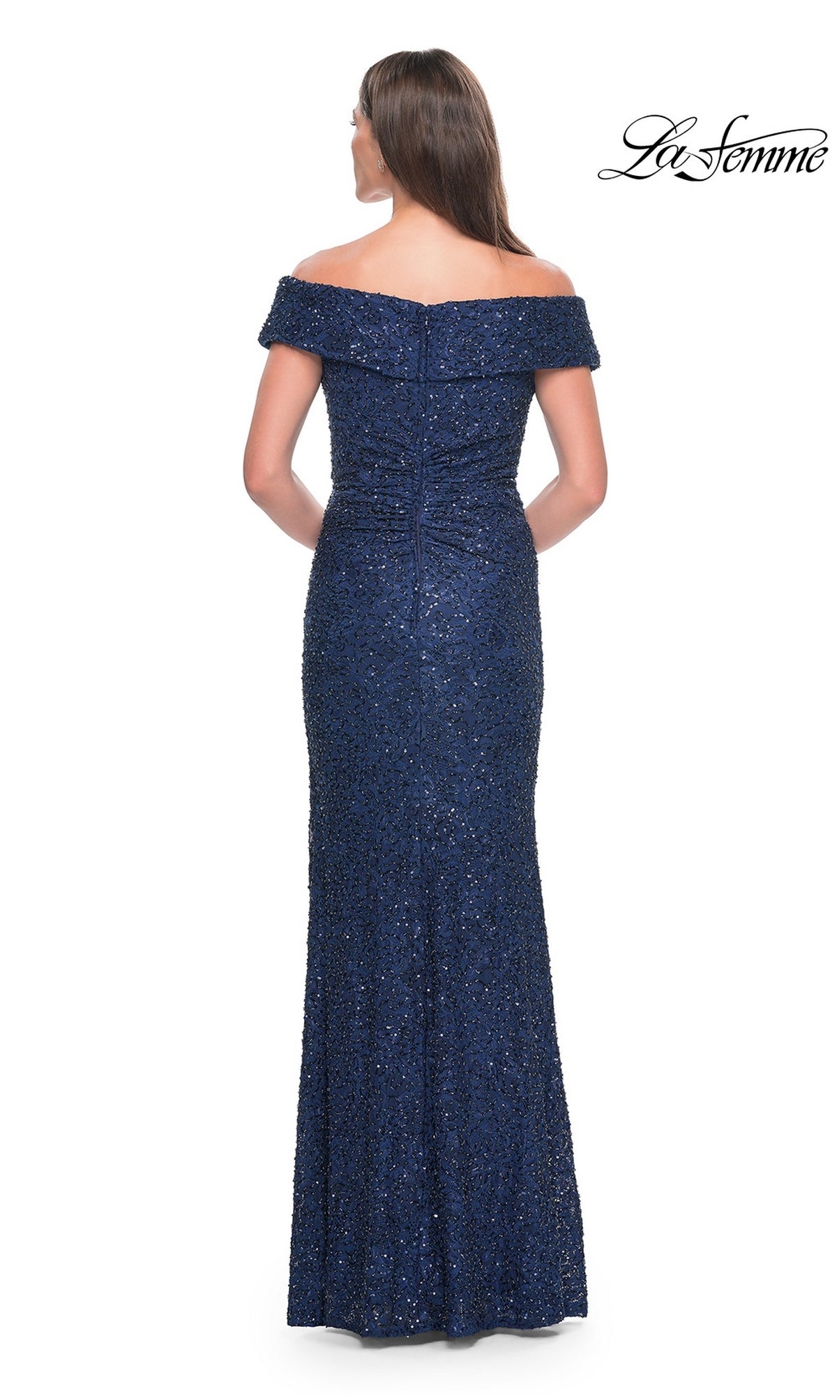 A woman viewed from behind wearing a floor-length, off-the-shoulder navy blue Long Formal Dress: La Femme 31679, covered in beaded lace and sequins.
